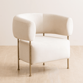 Buda Lounge Chair with modern design, plush upholstery, and hammered texture brass finish on stainless steel legs. Perfect lounge chair for bedroom.